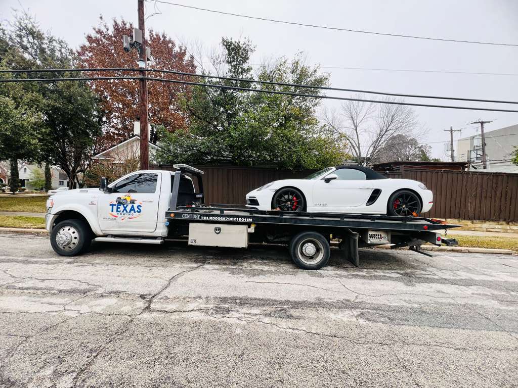 Texas Towing transporting a white sports car